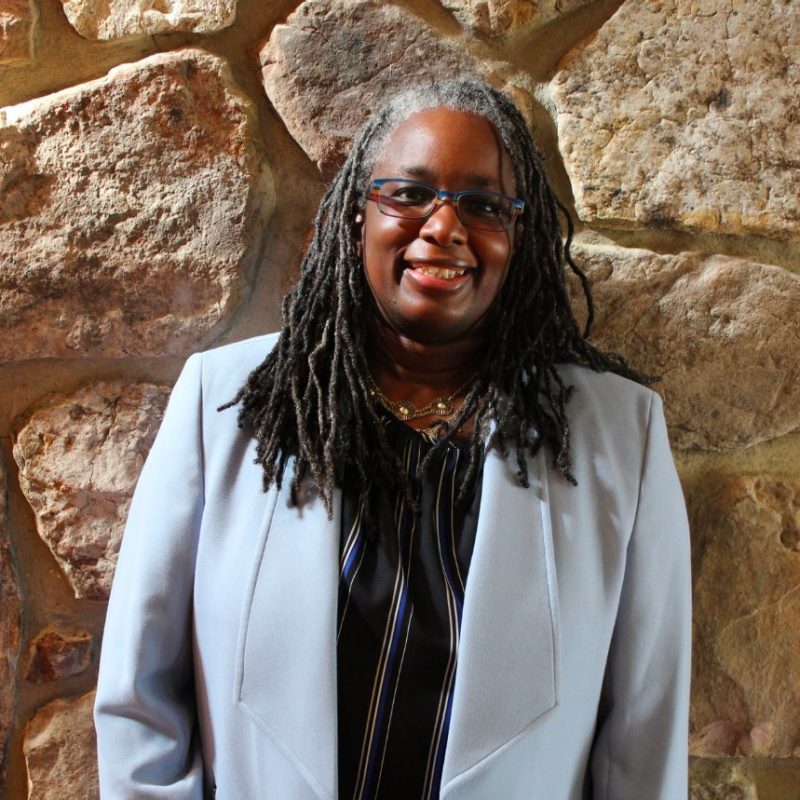 Vice President for Strategic Affairs and Diversity, Dr. Menah Pratt-Clarke Vice President for Strategic Affairs and Diversity, Dr. Menah Pratt-Clarke in a blue suit standing in front of a stone wall.